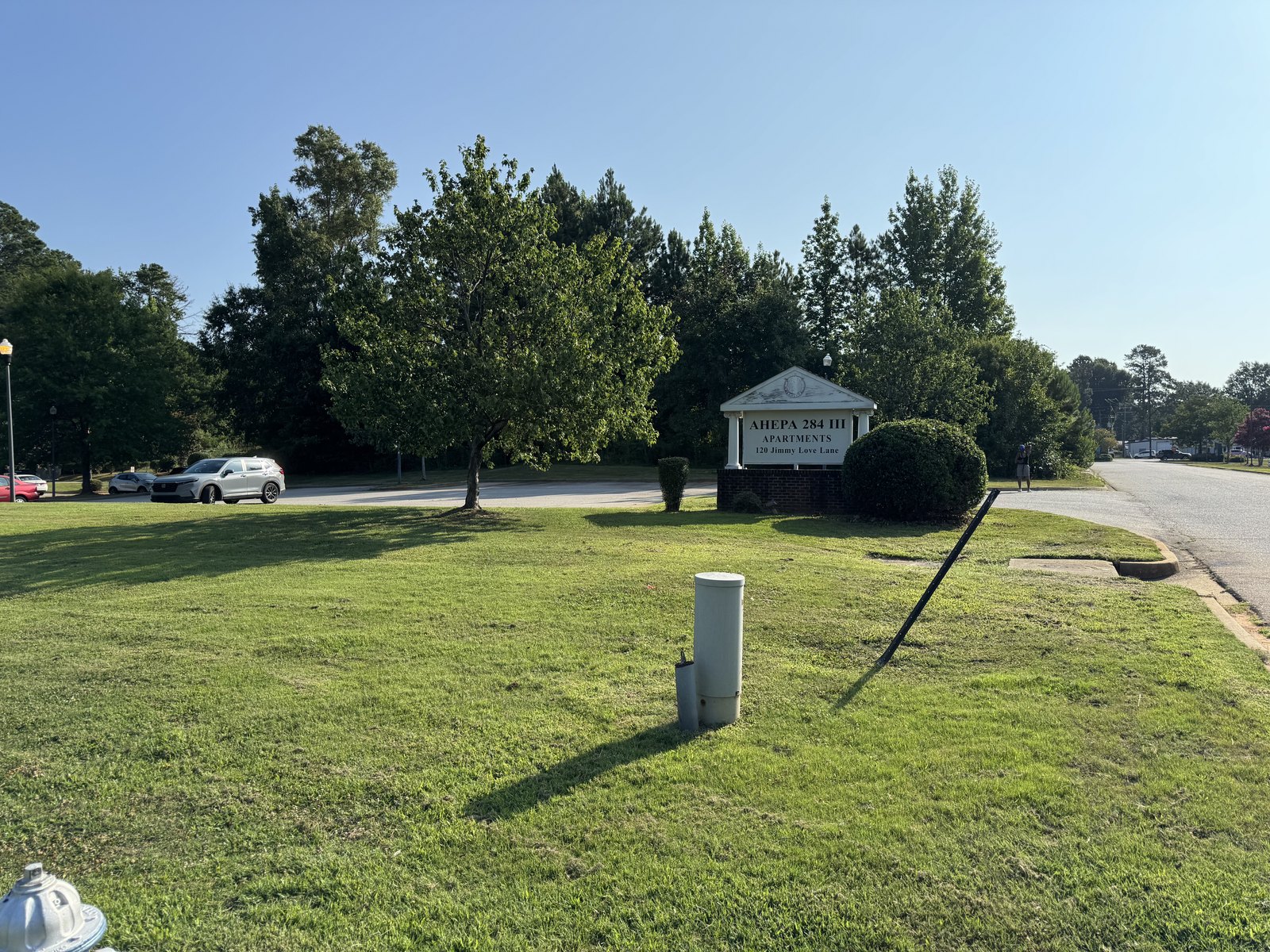 Maintained apartment-community entrance lawn and landscape