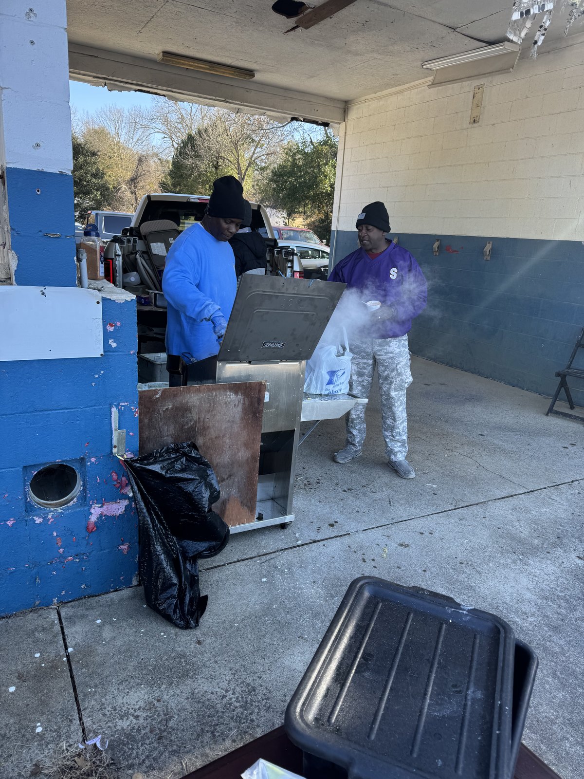 Food preparation underway during a community outreach event