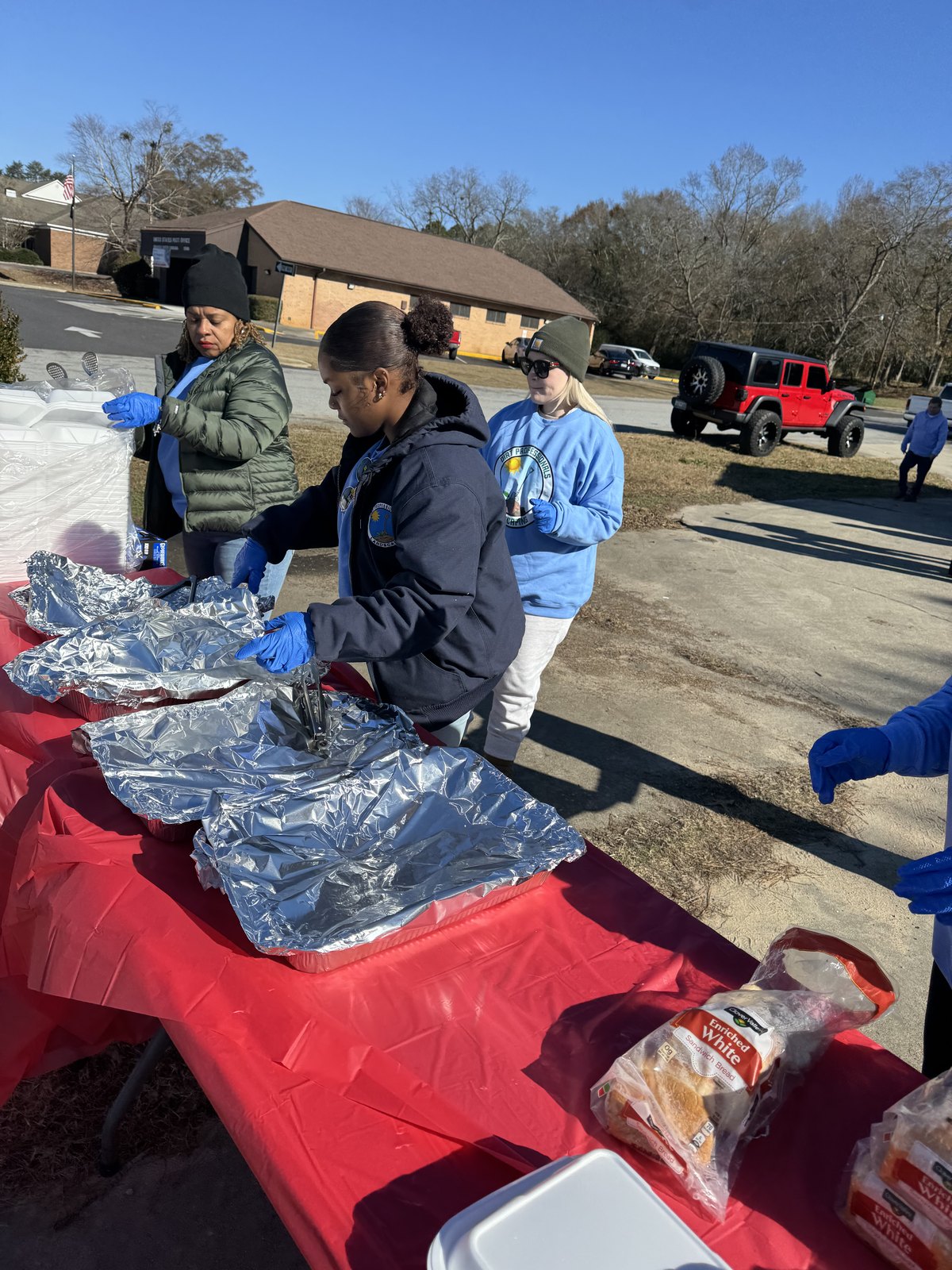 Volunteers preparing a community serving table